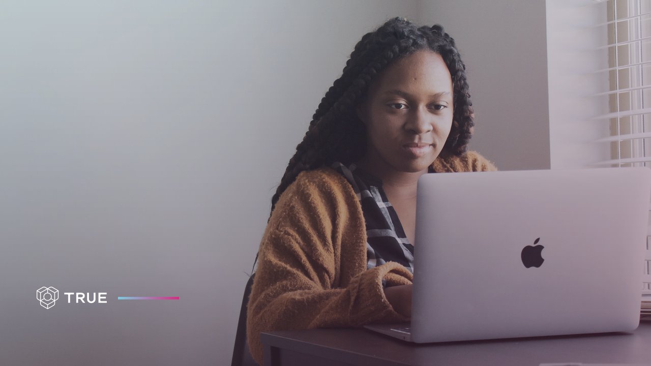 AI visibility: a woman at a laptop checking how her company appears in AI search